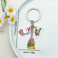 Porte-clés de Noël avec pendentifs Père Noël, renne et bonnet sur anneau argenté - Père Noël dans un Sac et Chapeau Rouge (ER826)