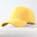 Detailed view of the yellow faux suede texture and stitching on a classic baseball cap - Yellow
