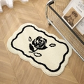Irregular cream flower rug with black rose pattern on herringbone wood floor - Rose Pattern-White