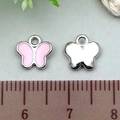 Pink enamel butterfly charm in silver metal finish showing size on measuring ruler - 1pc Pink Butterfly