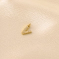 Golden letter V pendant necklace with micro-paved cubic zirconia on silk background - Gold Rhinestone Letter-V