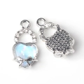 Macro view of a silver heart pendant with light blue gemstone and bow decoration - Silver Base Blue