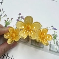 Three linked yellow frangipani hair claws in amber translucent resin for women - Yellow