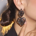 Elegant long black rhinestone double heart drop earrings worn by a female model - Black Double Heart Style (DTE1516022GU-BK)