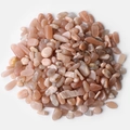 Polished natural pink and orange moonstone crystals scattered on a clean white background - Sunstone / 5-7mm 100g