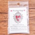 Silver Pocket Hug token with red heart enamel on greeting card in packaging - Silver Base Heart