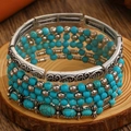 Detailed close-up of bohemian turquoise beads and engraved silver floral metal plates - Antique Silver Turquoise Multilayer Bangle (X394)