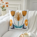 White square cushion featuring vibrant orange and yellow tulip floral embroidery on a sofa - Row of Lotus (Cover Only)