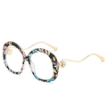 Chic round sunglasses with floral print frames, wavy gold metal temples and pearl accents - Floral + White