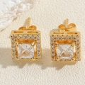 Macro detail of square gold-plated stud earrings with pavé cubic zirconia halo - White