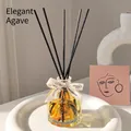 Minimalist agave reed diffuser set with glass bottle and black reeds on a white stand - 100ml / Elegant Agave