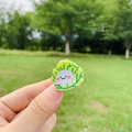 Close-up of a cute green cabbage hair clip with a smiling face in a natural outdoor setting - Cabbage Style / Mini (2cm)