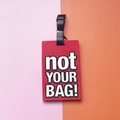 Red PVC luggage tag with bold white not YOUR BAG text and black adjustable strap - not YOUR BAG Slogan / Red