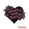 Detail of heart-shaped embroidered patch with floral design and Love and Peace text - LOVE AND PEACE Black Heart