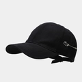 Detail of black cotton baseball cap with silver safety pin accent in streetwear style - Black