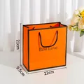 Medium size orange gift bag with Best Love text and black woven handles - Medium / Orange