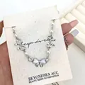 Elegante bracciale in argento con perle bianche, ciondolo a fiocco in occhio di gatto e zirconi - Argento (Fiocco Occhio di Gatto)