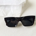 Detailed close-up of glossy black square sunglasses frames on textured background - Black Frame Full Grey