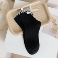 Black mid-calf socks featuring white ruffled edges and delicate satin bows in JK style - One Size / Black
