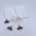 Detailed view of bug-themed necklaces with green and brown gemstones in a white gift box - Green Wing Beetle Pendant