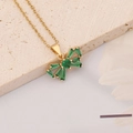 Close-up of golden bow pendant necklace with green emerald zircon inlays on stone - Bowknot Style (11#)