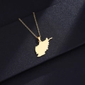 Macro shot of gold-tone Afghanistan map pendant necklace on a dark textured background - Gold Plain Map Necklace