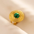 Detail of gold adjustable ripple ring with green malachite stone on beige fabric - Gold Base-Green Stone
