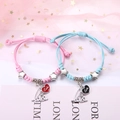 Geflochtene Armbänder für Paare in Rosa und Blau mit silbernen Sternperlen und Herzanhängern - Große und kleine Liebe (2er-Set - Buntes Seil)
