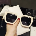 Detailed view of oversized square cream sunglasses with dark lenses and leather case - White