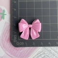 Top-view of a pink resin bow accessory on a scale mat showing size measurements - Rose Red Double Layer Bow / Rose Red