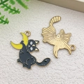 Cartoon black cat hugging crescent moon pendant with gold metal finish and black enamel - Cat Hugging Moon