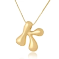Close-up of golden bubble letter K pendant with polished liquid metal finish on a box chain - K (D1013)