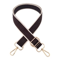 Close-up of geometric pattern jacquard bag strap with gold metal lobster clasps - Brown