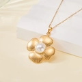Golden flower necklace with textured petals and inlaid pearl on a geometric white pedestal - Textured Five-Petal Flower Pearl Style (137519)