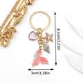 Pink mermaid tail keychain with starfish and shell charms, dimensions 8.2cm by 3cm - ER590-Enamel Pink Ocean Mermaid Tail Starfish Conch Heart
