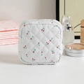 Quilted white storage bag featuring red cherry prints with a secure top zipper closure - White with Cherries