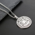 Macro detail of silver stainless steel tiger head pendant with Greek key border pattern - Steel Tiger