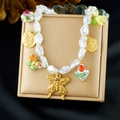 Detailed macro view of Baroque pearl necklace with golden butterfly and floral pendants - Rare Butterfly Floral Style (N3744)