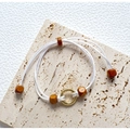 Handwoven white braided bracelet featuring golden ring accent and reddish-brown wooden beads - White Woven Rope Golden Ring Wood Beads Bracelet
