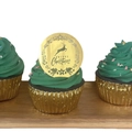 Close-up of golden acrylic Merry Christmas cupcake topper with elk and wreath designs - Gold Reindeer Style