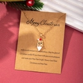 Close-up of golden Santa Claus enamel pendant on a kraft paper Christmas wish card - Santa Claus Head