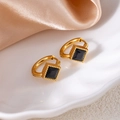 Close-up of gold stainless steel hoop earrings with square black gemstone on silk - Rhombus Zirconia / Black