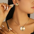 Golden daisy jewelry set with pearls featuring floral necklace, earrings and ring on model - Artificial Pearl Daisy Style (5201) / Gold