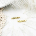 Macro shot of gold candy pendants with micro-pave crystals on soft white feathers - Heart with Arrow
