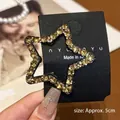 Close-up of a 5cm star-shaped hair clip with yellow rhinestones on a metal base - Approx. 5cm / Champagne Rhinestone Star