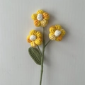 Handmade crochet puff flower stem in yellow and white yarn with green leaf - Gradient Yellow