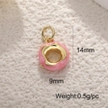 Macro shot of 14x9mm pink glitter enamel donut pendant with gold plating details - Pink Donut