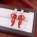 Close-up of vintage red bow drop earrings with zircon and gold texture on jewelry box - Gold/Red (S925 Sterling Silver Pin)