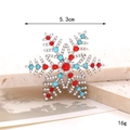 Detail of snowflake brooch with red and blue rhinestones on stone background - D2719 Colorful Snowflake