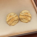 Detail view of gold textured round earrings featuring a wavy pleated surface on satin - Real Gold Plated Round Style (Silver Pin)